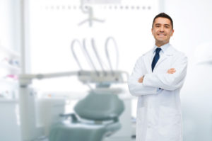45904875 - healthcare, profession, stomatology and medicine concept - smiling male middle aged dentist over medical office background